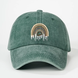 Detailed close-up of dark green washed denim baseball cap with rainbow Mama embroidery