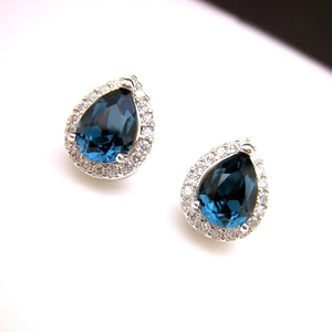 Classic teardrop blue sapphire stud earrings with cubic zirconia halo in silver setting