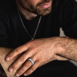 Men's 304 stainless steel faceted geometric ring with a matte finish on a male model's hand
