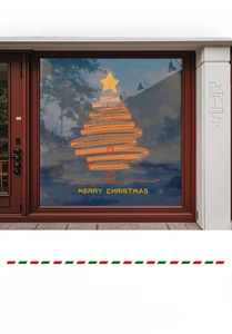 Close-up of orange Christmas tree window sticker with Merry Christmas greeting on glass