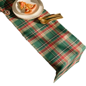 Christmas plaid table runner with red and green check pattern and festive dining accessories