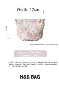 Detail of floral jacquard pouch showing texture and H&R BAG woven label in pink and white