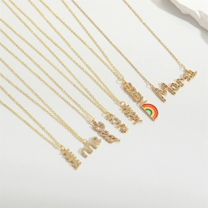 Detailed view of assorted gold plated necklaces with MAMA and MAMA enamel crystal pendants