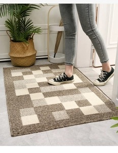Action shot of non-slip beige and brown checkered doormat in an entryway setting