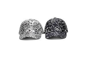 Detail of two-piece baseball cap set featuring all-over star prints in silver and black