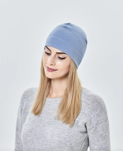 Detail of light blue knit beanie showing soft textured fabric and classic round top shape