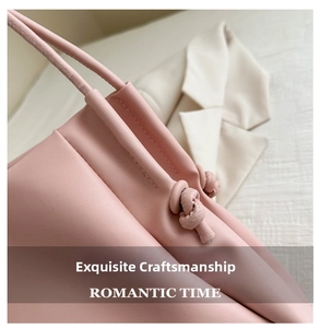 Close-up of precision stitching and decorative knot detail on pink leather tote bag