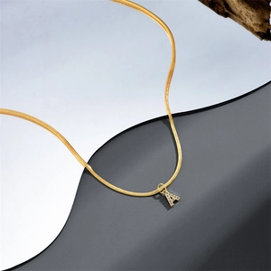 14k gold-plated snake chain necklace with sparkling zircon letter A pendant on reflective surface