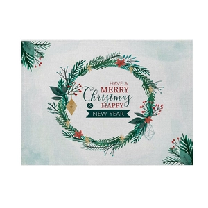 Detail of Christmas wreath print on linen placemat with festive berries and greeting
