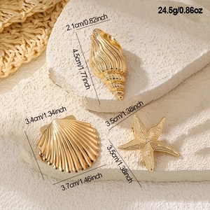 Golden ocean theme hair clips set featuring starfish, seashell, and conch designs