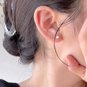 Minimalist 925 sterling silver pearl stud earrings set shown on model ear for women