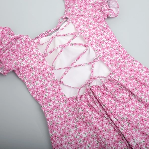 Detailed view of the lace-up back design on a pink floral summer maxi dress