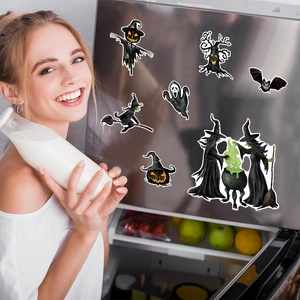 Smiling woman in kitchen with Halloween dwarf and pumpkin magnetic fridge stickers
