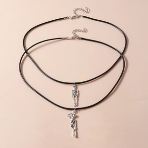 Detail of silver skeleton pendants on black cord necklaces with lobster clasp closures