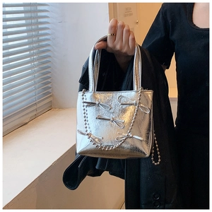 Silver handbag with metallic finish and cute bows featuring a stylish bead chain strap
