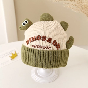 Detail showing embroidered dinosaur pattern and cute text on kids warm knit winter hat