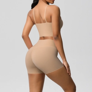 Macro detail of seamless nude two-piece yoga set with thin straps and high-waist shorts