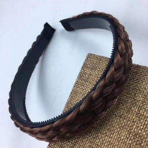 Detailed view of brown braided headband with non-slip inner teeth for hair styling