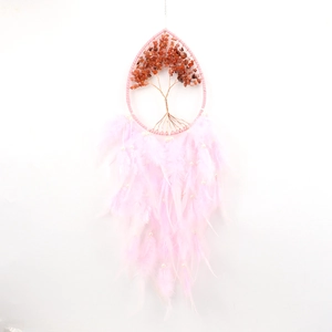 Macro detail of pink dreamcatcher with tree of life copper wire and natural feathers