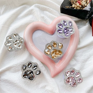 Close-up of luxury cat paw phone grips with sparkling rhinestones in five elegant colors