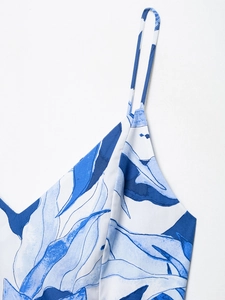 Detail of blue leaf print on woven fabric with delicate thin strap and fine stitching