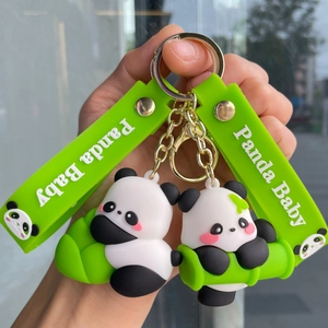 Detail of cute cartoon panda keychains with green wristbands and bamboo accents