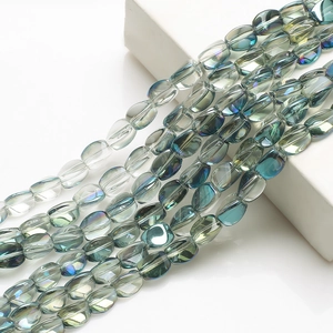 Macro shot of 10x12mm teal crystal beads with rainbow luster on white display block