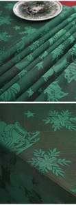 Detail of green lace Christmas table runner with snowflake and Santa Claus patterns