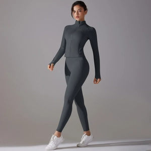 Detail shot of grey yoga set featuring thumb holes and high-waist stretch fitness leggings