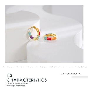 Detailed shot of golden bamboo-style earrings with colorful enamel drip oil finish