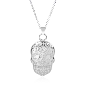 Detail of silver skull pendant necklace with intricate rose and heart engravings