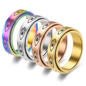 Detail of spinning stainless steel rings with evil eye patterns in four distinct colors
