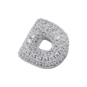 Macro shot of silver letter D charm with cubic zirconia pavé setting on white background