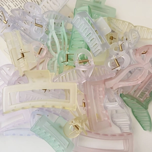 Assorted colorful matte acrylic hair claw clips with golden metal spring details