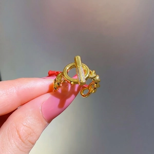 Gold chain ring featuring OT toggle design with sparkling pavé stones on T-bar