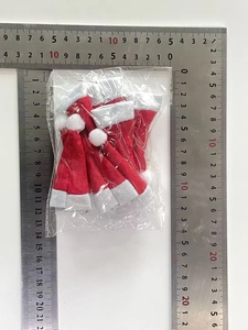 Mini red and white non-woven Christmas hats packaged for lollipop decorations with size rulers