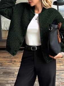 Detail of dark green textured fleece jacket with button closure on a female model