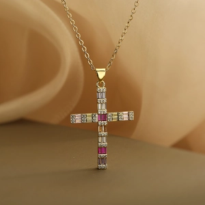 18K gold plated cross pendant necklace with colorful zircon stones on silk background