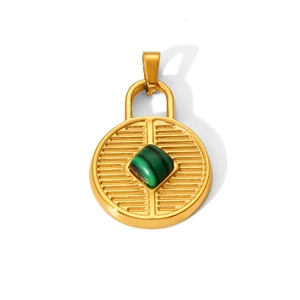 Detail of gold circular pendant with a green square gemstone and geometric textures
