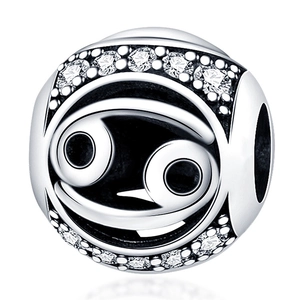 Macro shot of silver Cancer zodiac charm bead with shimmering white cubic zirconia stones