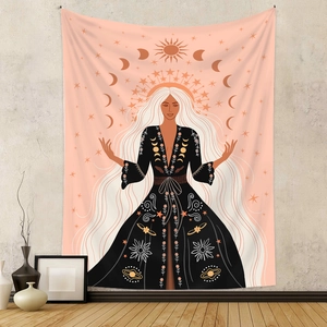 Bohemian sun and moon tapestry with celestial woman figure hanging on a grey wall