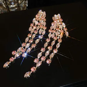 Luxurious long tassel earrings with pink and clear crystals in a geometric gold setting