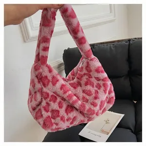 Detailed shot of pink leopard plush faux fur handbag with zipper and soft texture
