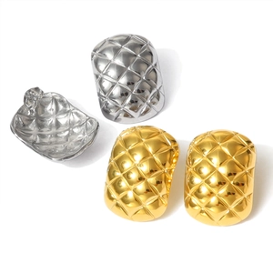 Close-up of geometric quilted texture on gold and silver stainless steel stud earrings