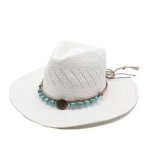 White handwoven bohemian jazz straw hat with turquoise beads and sun totem charm