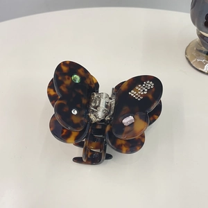 Elegant butterfly claw clip with tortoiseshell pattern and inlaid colorful gemstones