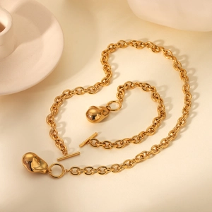 Detail of gold chunky chain necklace featuring OT toggle clasp and lava-style drop pendant