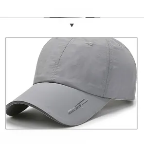 Macro detail of breathable grey sports cap featuring embroidered lettering and reflective strip