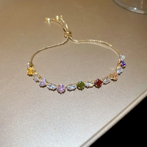 Close-up of golden adjustable bracelet with multi-color zircon marquise and square stones