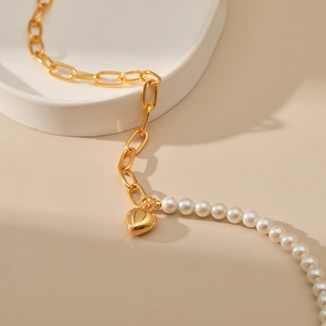 Elegant French-style gold paperclip chain necklace with white pearls and a heart pendant
